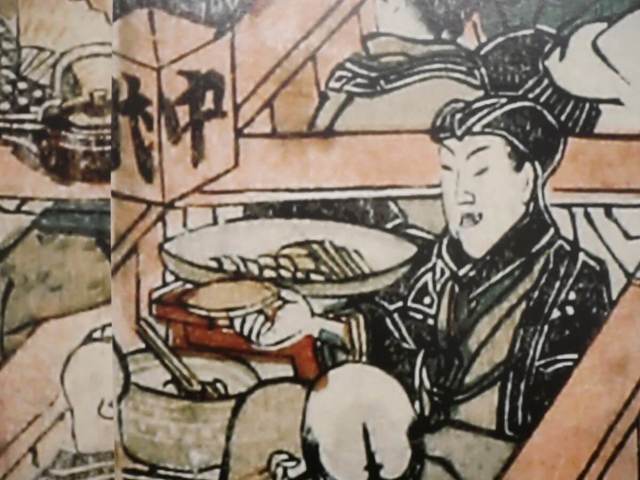 座席で飲食を楽しむ人々が描かれている。第1章会場内、歌川豊国《中村座内外の図》の拡大プリントを施した壁面の一部