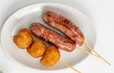 「【賴ママ食堂】(左)香腸(ソーセージ)/(右)花枝丸(揚げイカだんご)」<価格:税込500円>【日本初上陸“台湾スイーツ”や人気の“台湾フード”が勢揃い!『你好!台湾展』大丸福岡天神店で初開催!】