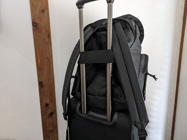 【GU ナイロンツイルバックパック+E】背中側のベルトをスーツケースの持ち手に通しました。ずり落ちず運びやすい！