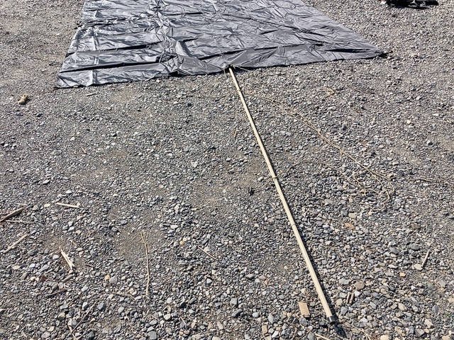 【ワークマン レジストスクエアタープ】タープを地面に置いた状態で中央の穴にポールをセット