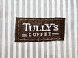 フロント右下部には、ブラウンの「TULLY'S COFFEE」の織りタグ付き