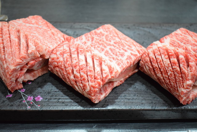 骨の部分を中心に巻いた状態で出てくる『大関嶺韓牛タウン』の生（セン）カルビ200グラム50000ウォン。生カルビとはタレにからめたヤンニョム・カルビに対する言葉で、味付けしていない肉のこと。ヤンニョム・カルビも同価格