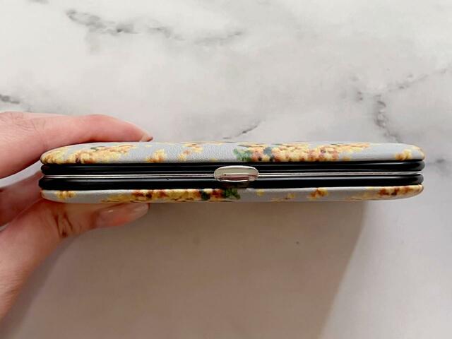 サイドのシルバーの金具で開閉する仕様