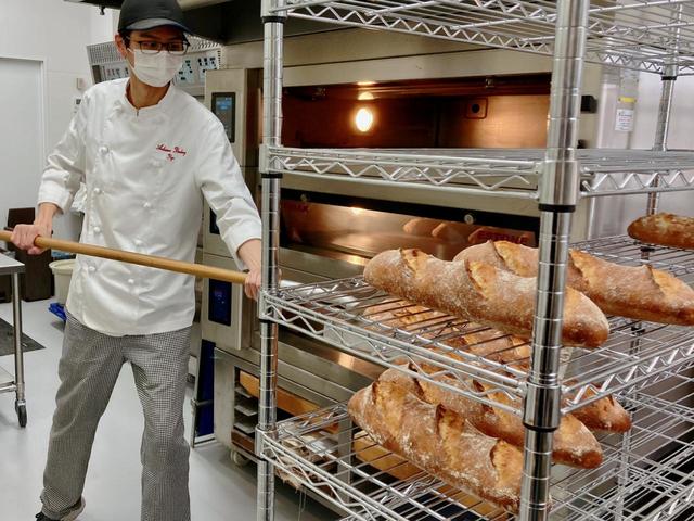 ドイツでの修業を終えた亮さんが厨房でパンを焼いている