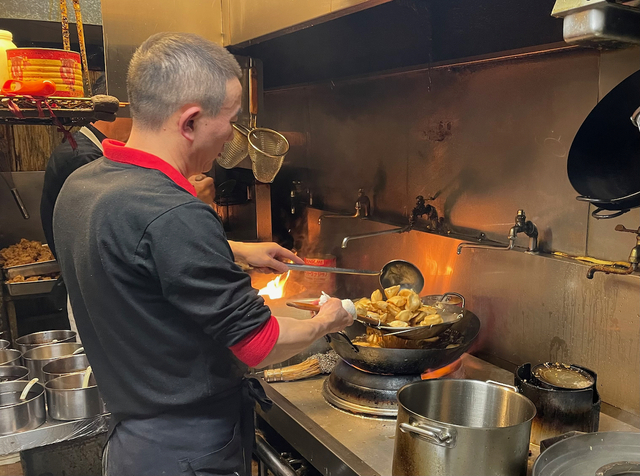 【九寨溝 銀座店】鍋をふるう林シェフ。小籠包は厨房内の別の場所で蒸されていた