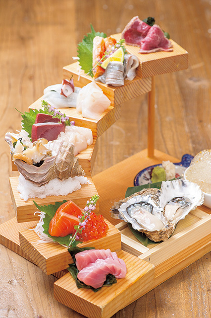 北海道ろばた 居心地（大通エリア） 階段刺身盛り合わせ 一人前 1050円（※写真は二人前） 函館のマグロ、厚岸の牡蠣など階段上に盛られた刺身はすべて道内産。階段の1番上はサフォークラムのたたき。