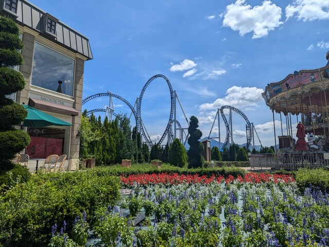 【富士急ハイランド・リサとガスパール タウン】アトラクションをバックにトリコロールカラーのガーデンが映える