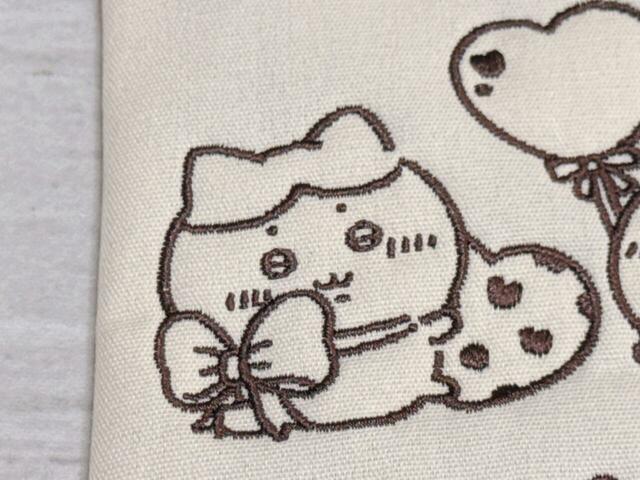 首の大きなリボン姿が悶絶急にかわいいハチワレ。小さなおててでチョコレートを持っているのがたまりません…！