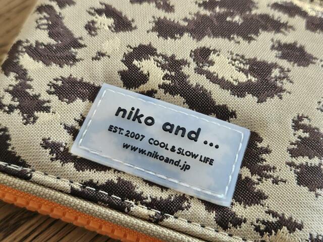 【niko and…（ニコアンド） オリジナルストラップ付きZIP財布】本体正面のブランドロゴ。文字に立体感があっておしゃれ！