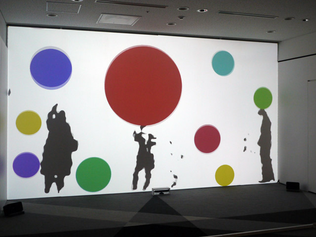 『Immersive Shadow(イマーシブ・シャドウ)』藤本直明／体験者の影が壁面に大きく映し出され、カラフルなボールがその影にぶつかったり避けたりする不思議な世界に、大人も子供も夢中。手や足を動かしてボールを動かしてみよう。